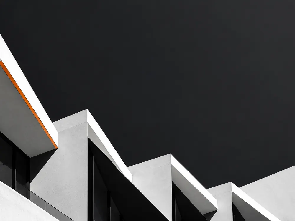 White stepped facade with an orange accent line